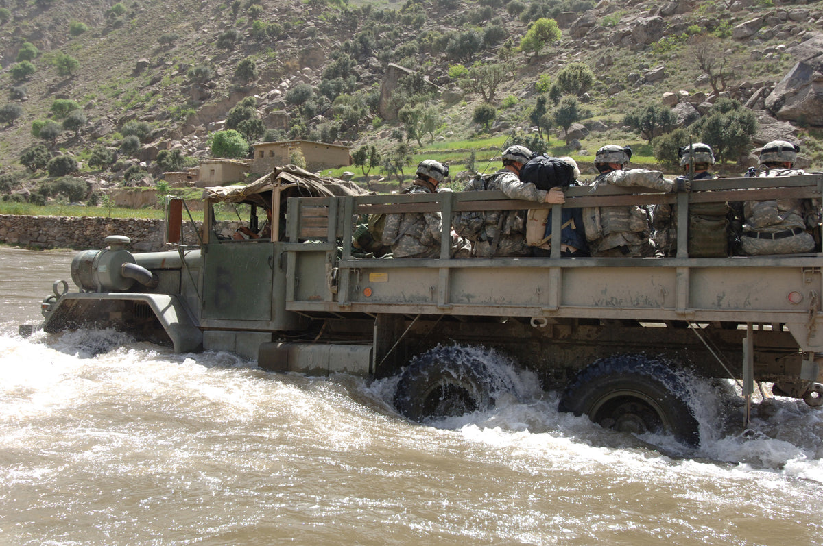 U.S. Army soldiers fording the Pech River in Kunar Province during operations in April 2006, illustrating the valley terrain central to the Kunar campaign