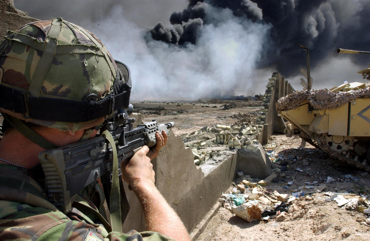 Irish Guards soldier covering Royal Engineers at a burning oil well in Basra, 3 April 2003