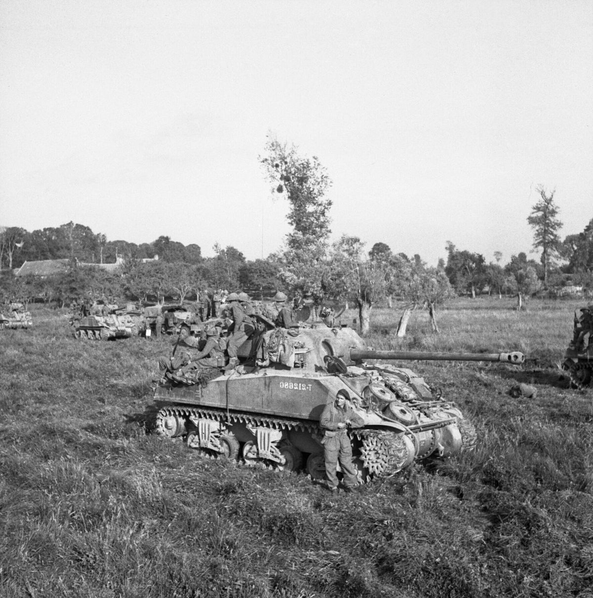 British infantry and Sherman tanks waiting to advance at the start of Operation Goodwood in Normandy on 18 July 1944