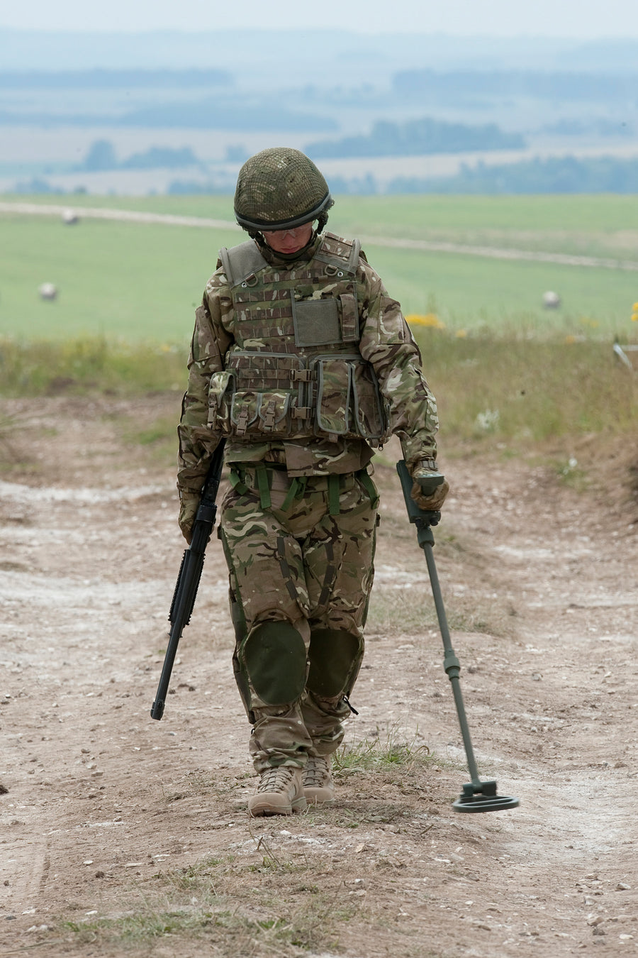 British soldier demonstrating protective equipment and a Vallon VMC1 detector
