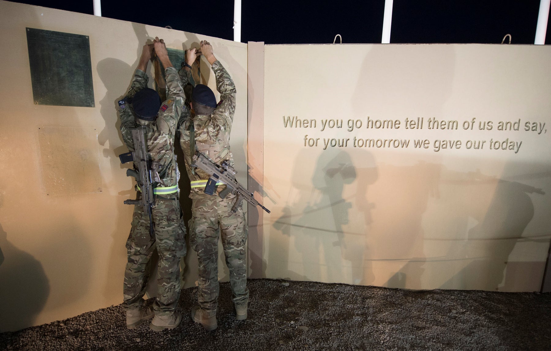 British troops removing name plaques from the Camp Bastion Memorial Wall for repatriation; remembrance context for Private Richard Hunt, not a portrait of him