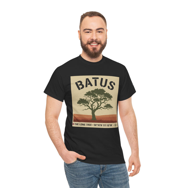 Black graphic tee by S&amp;W Gallus featuring a vintage safari tree, shown on a smiling model in jeans.