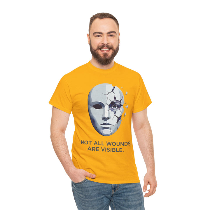 Yellow t-shirt by Veteran owned featuring a cracked mask graphic and a mental health awareness slogan, worn with jeans.