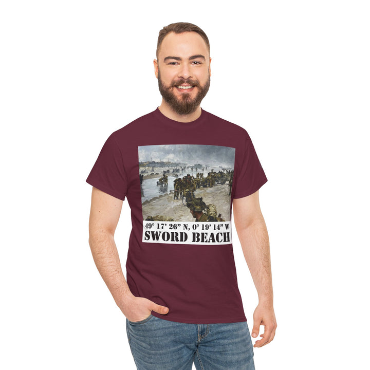 Maroon t-shirt by Veteran owned, displaying a painting of Sword Beach with its coordinates, paired with blue jeans.