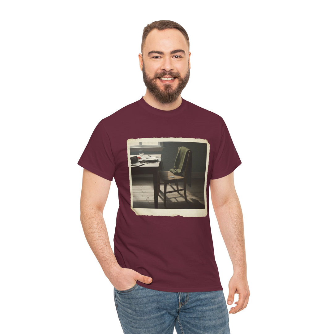 Maroon t-shirt by S&amp;W Gallus featuring an image of an empty study room, paired with blue jeans, on a man standing and smiling.