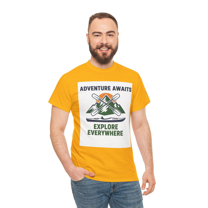 Yellow t-shirt by S&amp;W Gallus, featuring adventure-themed graphic with mountains, paddles, and kayak; worn with jeans on a model.
