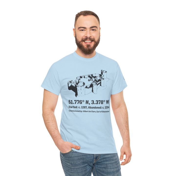 Light blue Morlais Castle T-shirt by S&amp;W Gallus, featuring a black castle sketch and geographic coordinates. Man wearing jeans with hand in pocket.