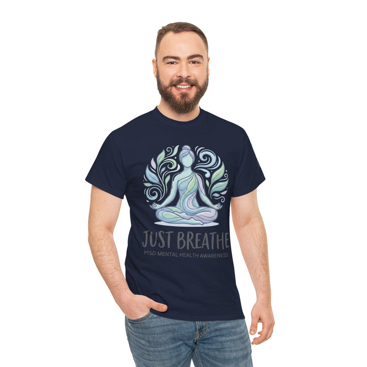 Navy blue t-shirt by Veteran Owned, featuring a yoga pose graphic and "Just Breathe" text, worn with jeans.