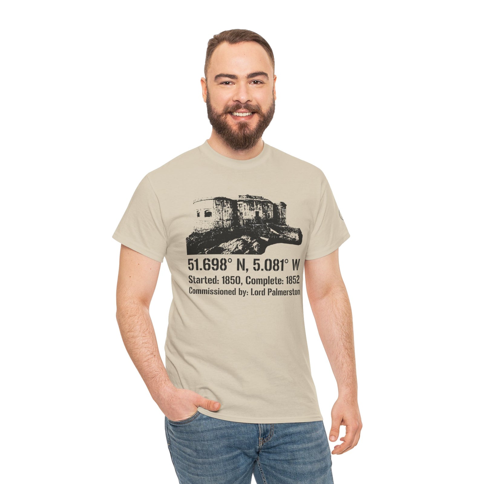 Beige graphic T-shirt by S&W Gallus, featuring a scenic coastal landmark image and coordinates, paired with jeans.