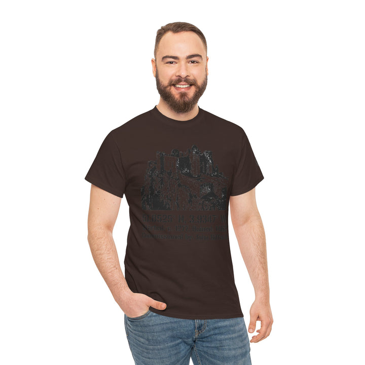 Brown Carreg Cennen Castle T-shirt by S&amp;W Gallus with a castle graphic and coordinates, worn with jeans.