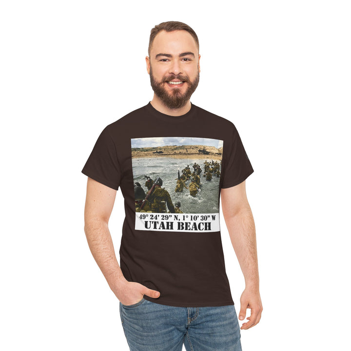 Brown graphic t-shirt by Veteran owned, featuring a vintage Utah Beach photograph and historical coordinates. The model is wearing jeans.
