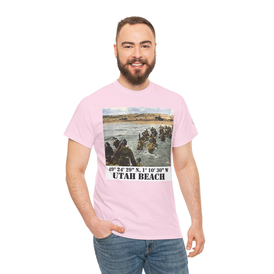 Pink Utah Beach D-Day T-shirt from Veteran owned, featuring a historical image and location coordinates, styled with blue jeans.