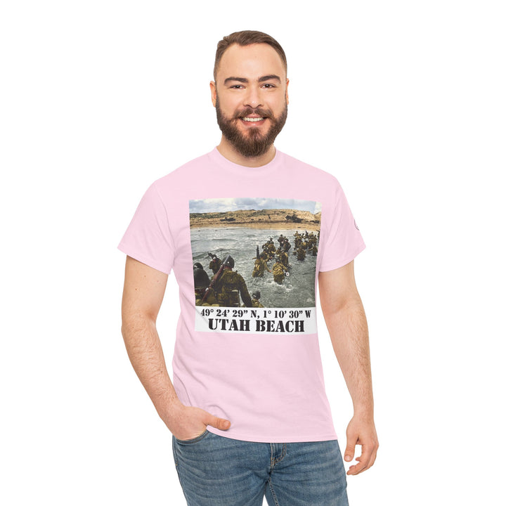 Pink Utah Beach D-Day T-shirt from Veteran owned, featuring a historical image and location coordinates, styled with blue jeans.