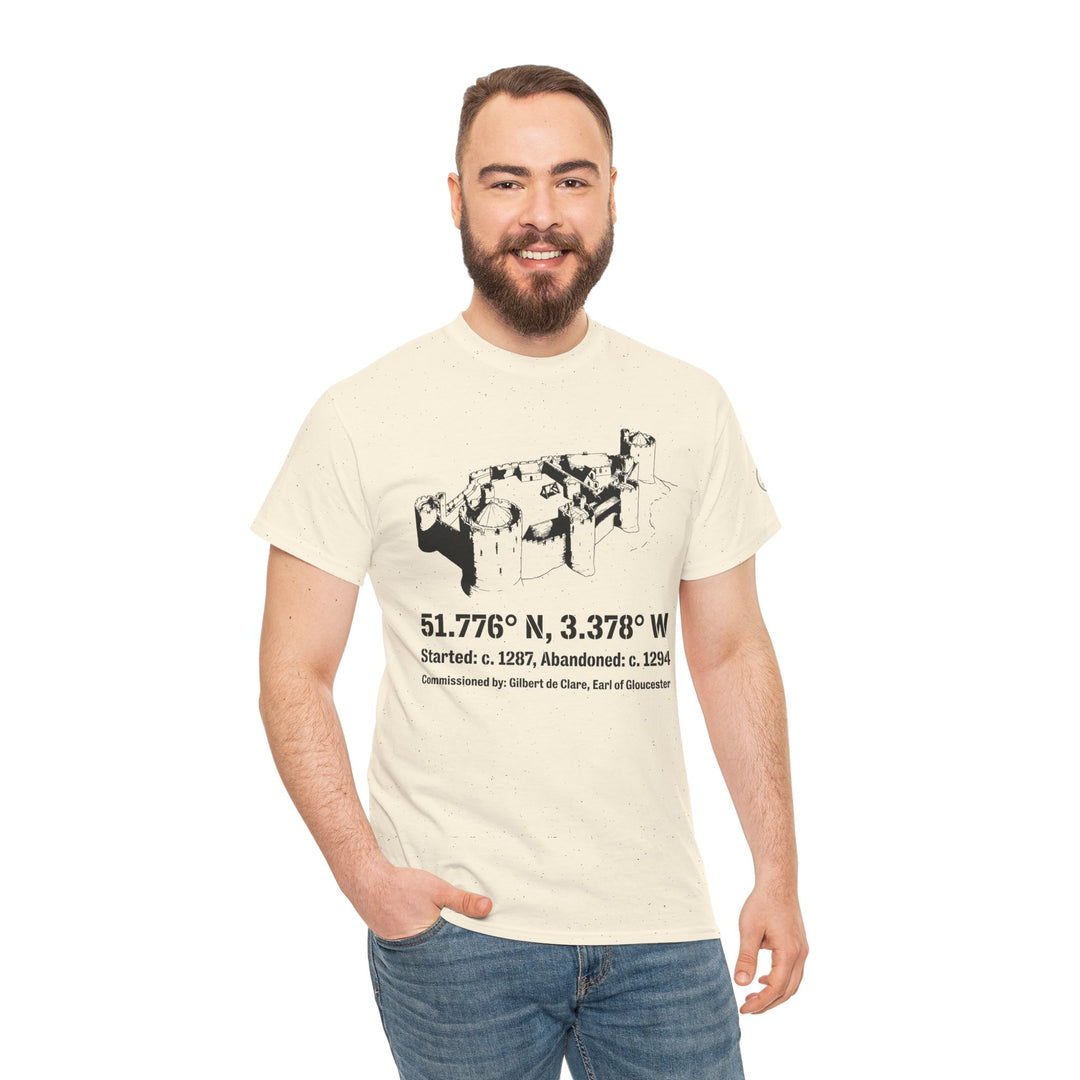 Beige Morlais Castle t-shirt by S&amp;W Gallus, featuring a black castle illustration with coordinates and construction information, worn with blue jeans.