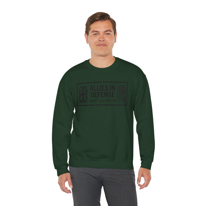Forest green crewneck sweatshirt by S&amp;W Gallus with "Allies in Defense" graphic on the front, paired with gray pants.