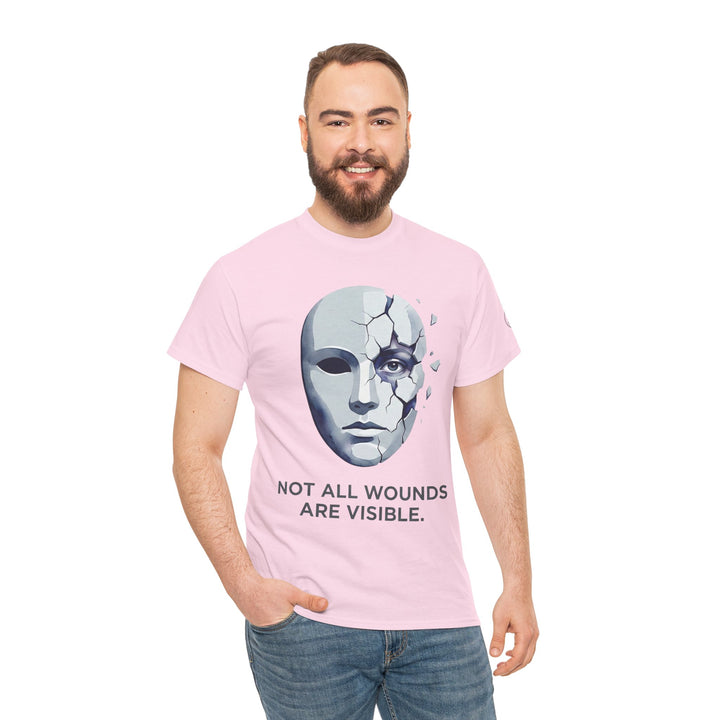 Pink T-shirt by Veteran owned, displaying a cracked mask and the words "Not All Wounds Are Visible" on a person.
