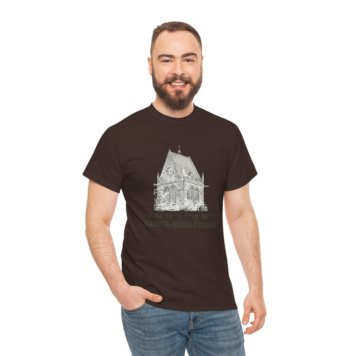 Brown Sainte-Mère-Église 1944 Vintage Church T-Shirt from Veteran owned, featuring a church sketch and coordinates, styled with jeans.