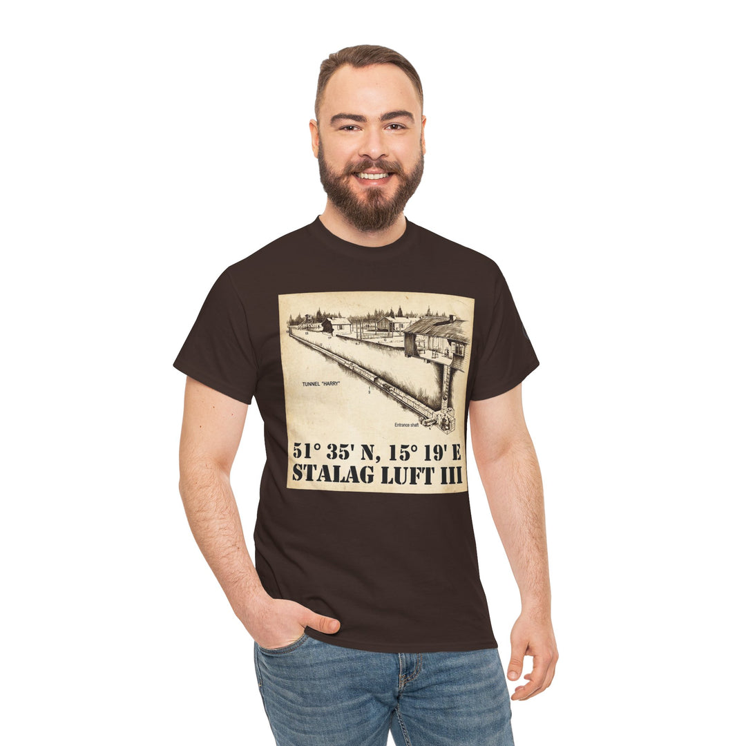 Brown graphic t-shirt with Stalag Luft III coordinates by Veteran owned, worn with jeans, on a smiling bearded man.