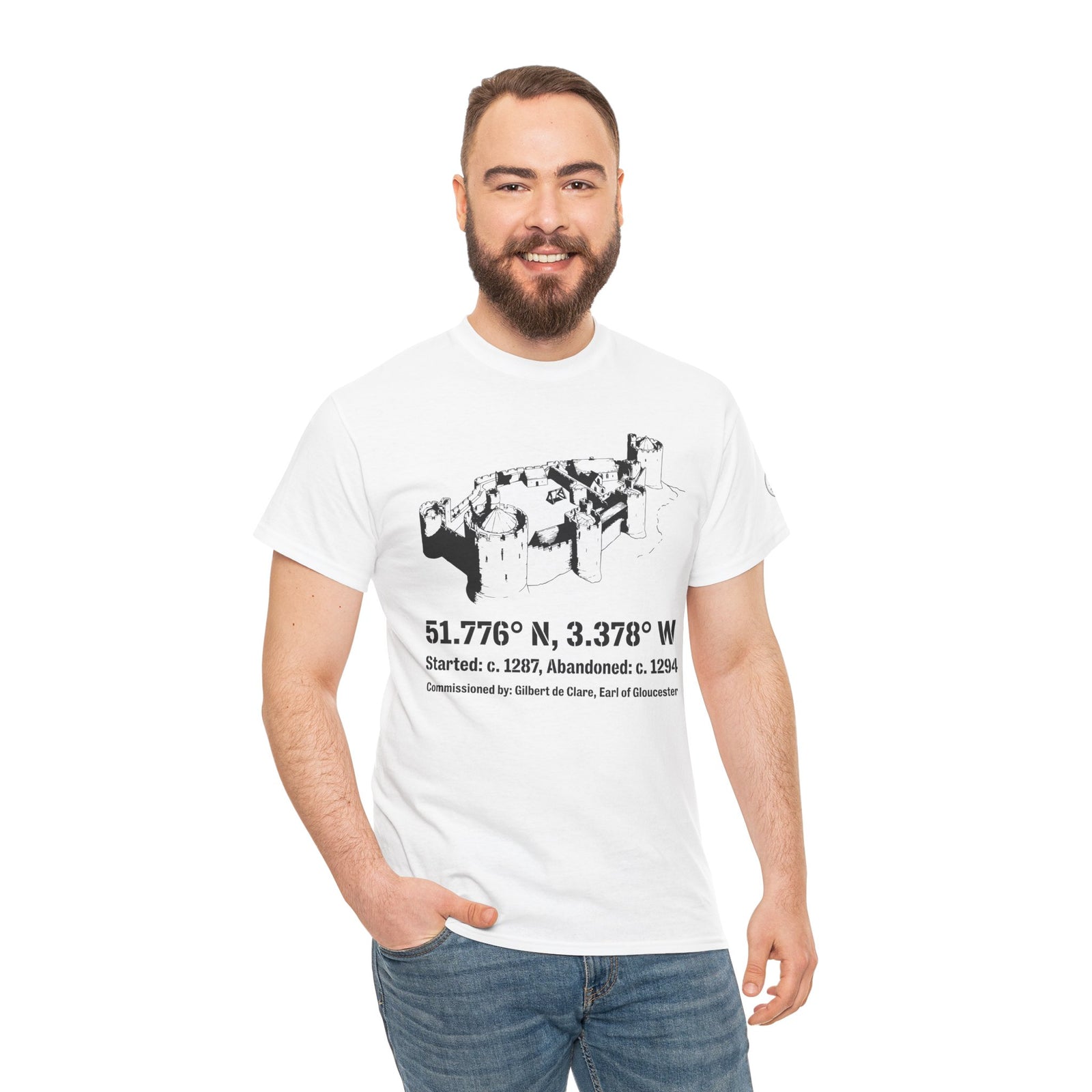 White Morlais Castle T-shirt by S&W Gallus, featuring a castle drawing with coordinates and commissioning information, worn with jeans.