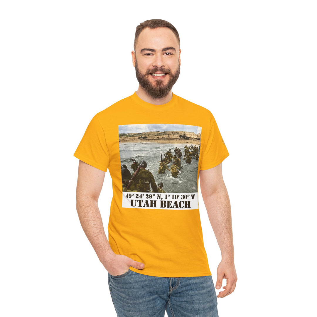 Yellow graphic tee shirt by Veteran owned, featuring a Utah Beach D-Day image, worn with jeans and hand in pocket.
