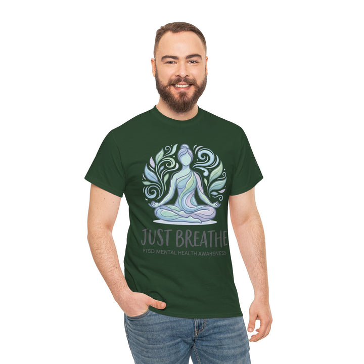 Green t-shirt by Veteran Owned, featuring a meditating figure surrounded by swirling leaves, paired with jeans.
