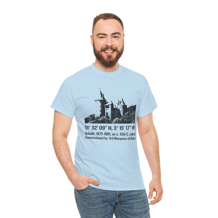 Light blue Castel Coch Fairytale Castle T-Shirt by S&amp;W Gallus, featuring vintage Welsh castle illustration, paired with jeans on a smiling man.