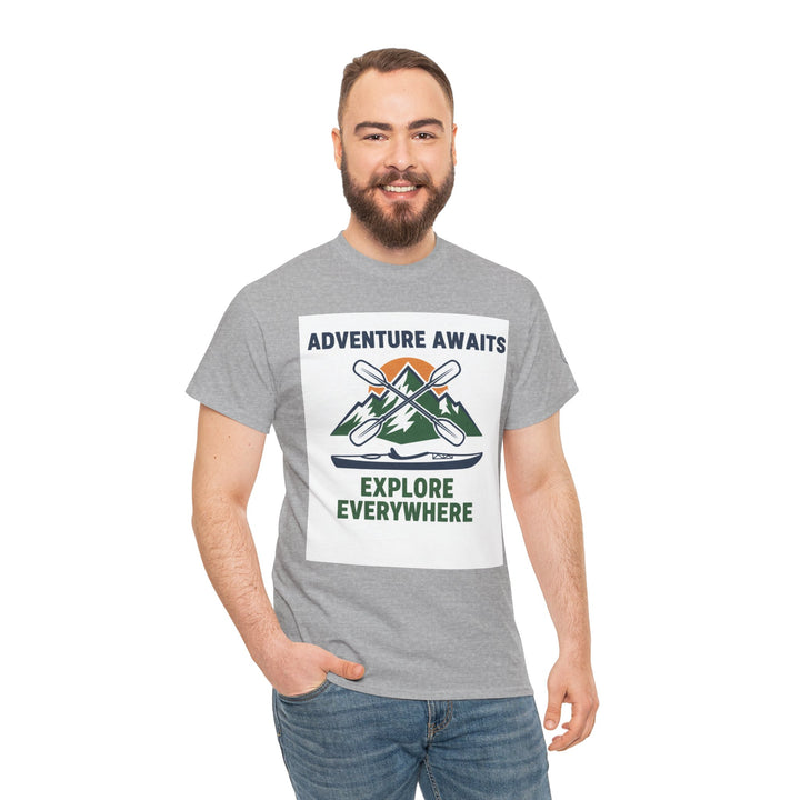 Gray adventure awaits T-shirt by S&amp;W Gallus, featuring a kayak and mountain graphic, worn with blue jeans.