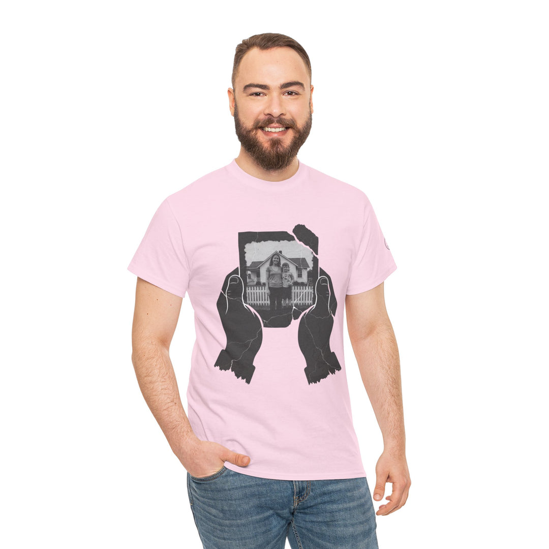 Pink t-shirt by S&amp;W Gallus, featuring graphic of hands holding a torn photo, worn with jeans.