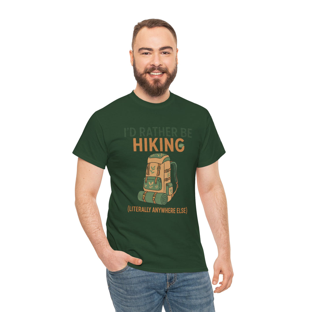 Dark green graphic T-shirt by S&amp;W Gallus, featuring a hiking backpack and humorous text, worn with blue jeans by a smiling man.