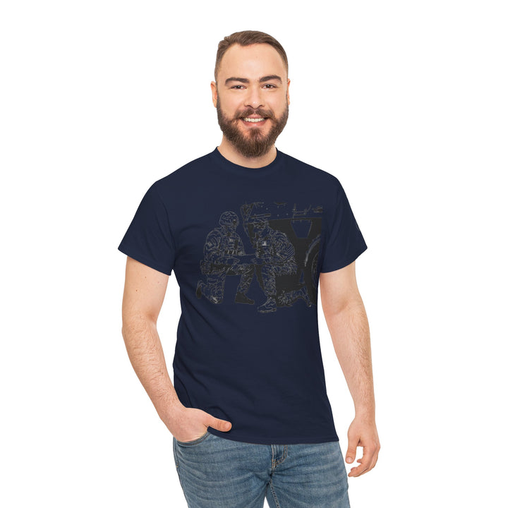 Navy t-shirt by S&amp;W Gallus with a graphic of soldiers and a vehicle, shown on a smiling man with jeans.