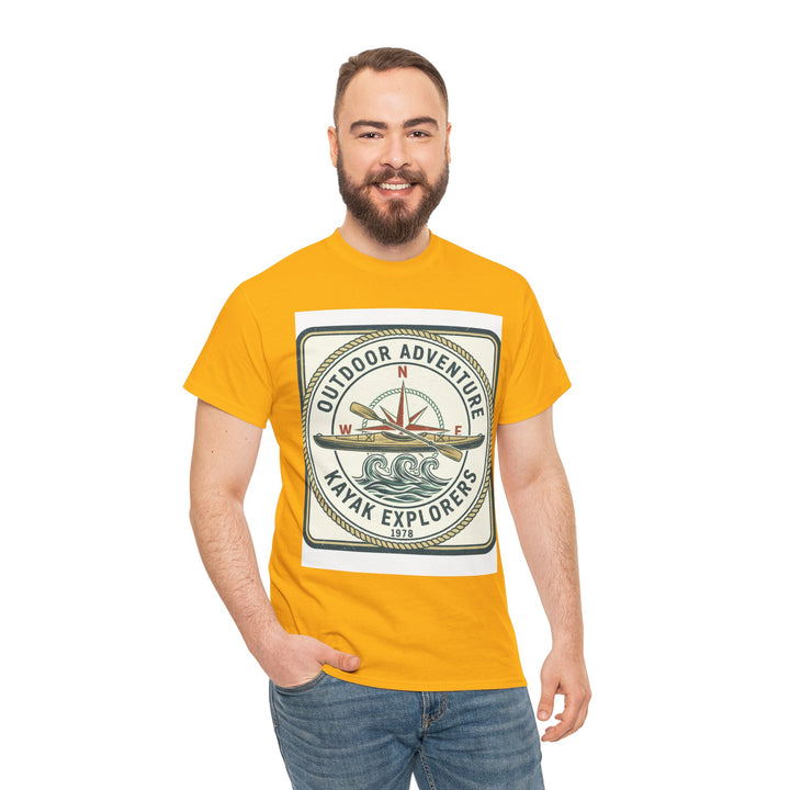 Mustard yellow t-shirt by S&amp;W Gallus, featuring a compass and kayak graphic, worn with jeans.