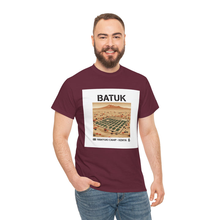 Maroon t-shirt with "Batuk Camp Kenya" graphic by S&amp;W Gallus, featuring a Nanyuki desert landscape and a smiling man in jeans.