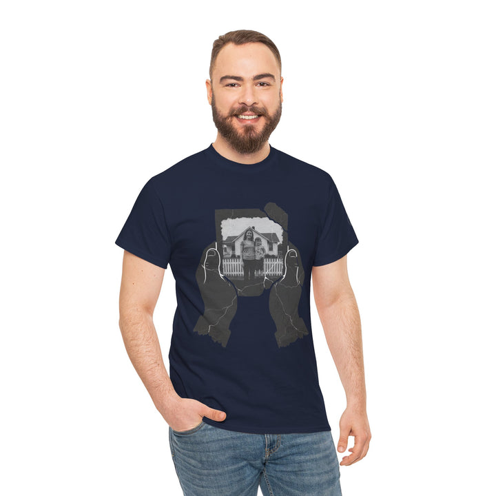 Navy t-shirt by S&amp;W Gallus featuring hands holding a cracked photograph, paired with jeans.