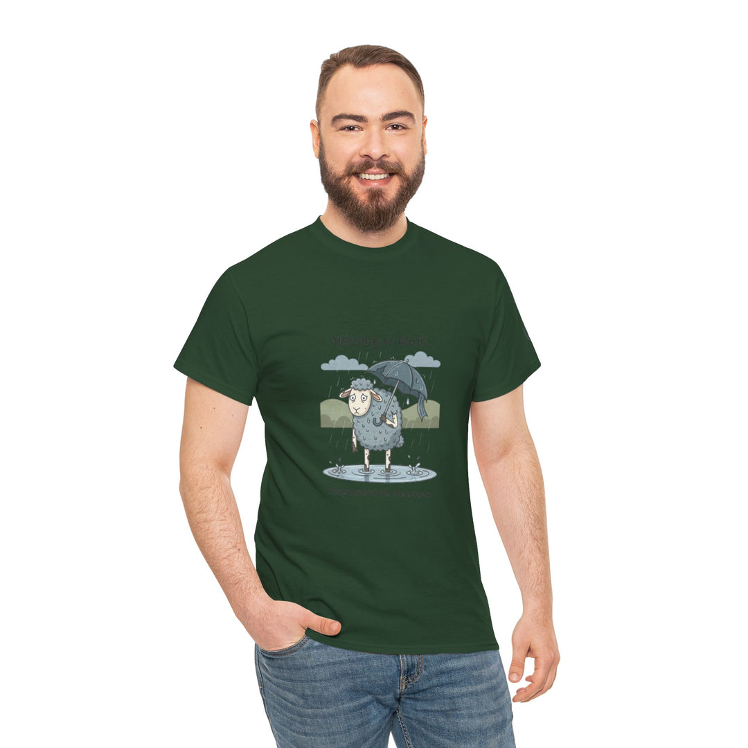 Green "Sheep in Wales" T-shirt by S&amp;W Gallus, featuring a cartoon sheep with an umbrella in the rain, worn with blue jeans.