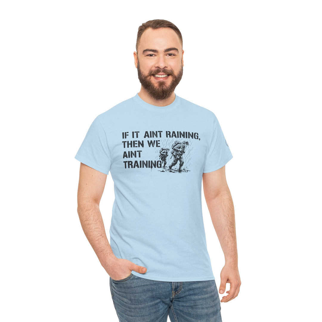 Light blue t-shirt with military-inspired graphic by S&amp;W Gallus, featuring soldiers in the rain and a humorous slogan.