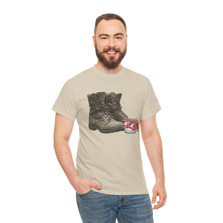 Tan T-shirt by S&amp;W Gallus featuring a pair of combat boots and red sneakers, worn with blue jeans.