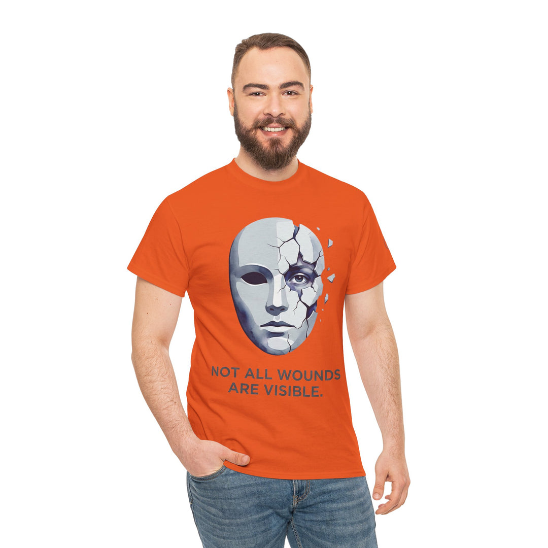 Orange t-shirt with a cracked mask graphic by Veteran owned, featuring a mental health awareness message, worn with blue jeans.