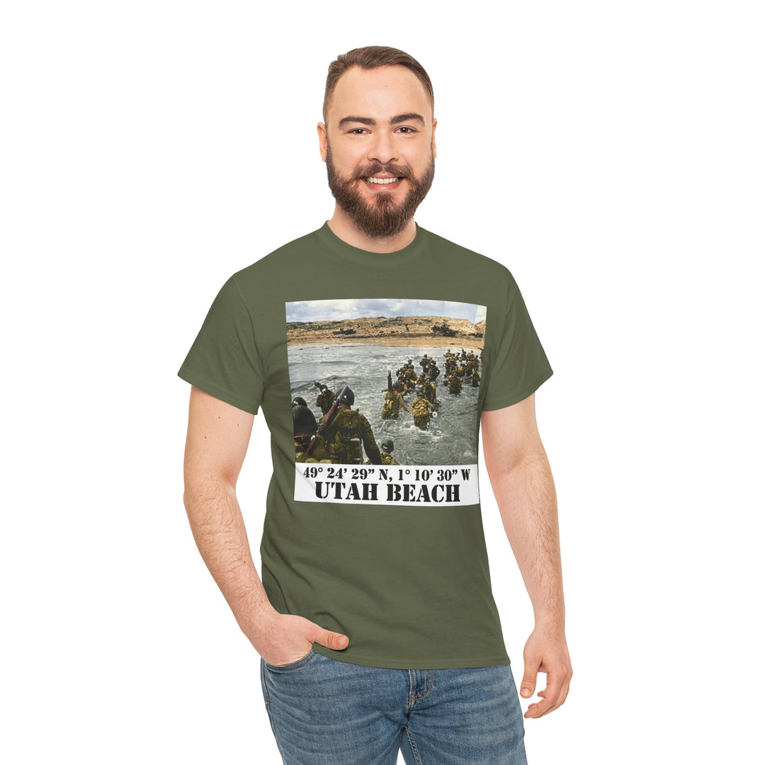 Olive green t-shirt by Veteran owned, featuring a WWII photograph and text about Utah Beach. Model also wears blue jeans.