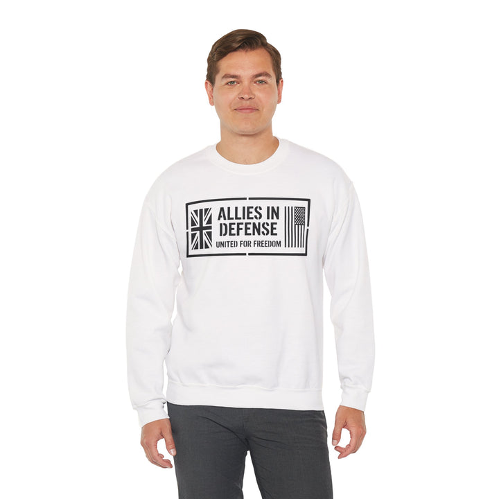 White crewneck sweatshirt by S&amp;W Gallus with "Allies in Defense" graphic print; worn with gray pants.
