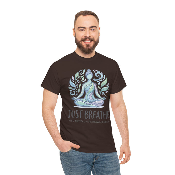 Brown graphic t-shirt by Veteran owned, featuring a yoga figure and "Just Breathe" text, styled with blue jeans.