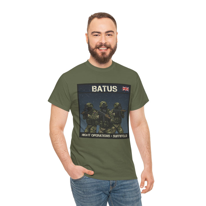Olive green graphic t-shirt by S&amp;W Gallus displaying soldiers in camouflage, worn with blue jeans.