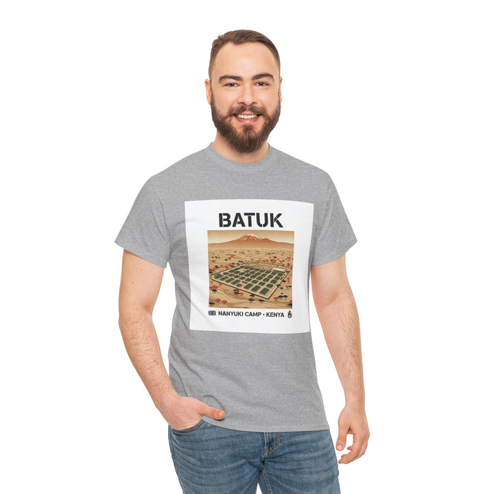 Gray graphic t-shirt by S&amp;W Gallus, featuring a desert landscape and "BATUK Nanyuki Camp Kenya" text, paired with casual jeans.