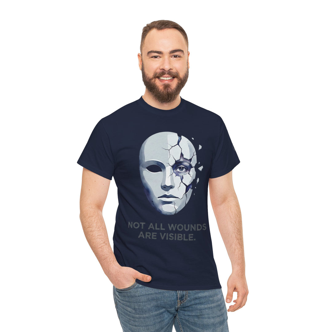 Navy t-shirt by Veteran owned, featuring a cracked mask graphic and the words, "Not All Wounds Are Visible," worn with jeans.