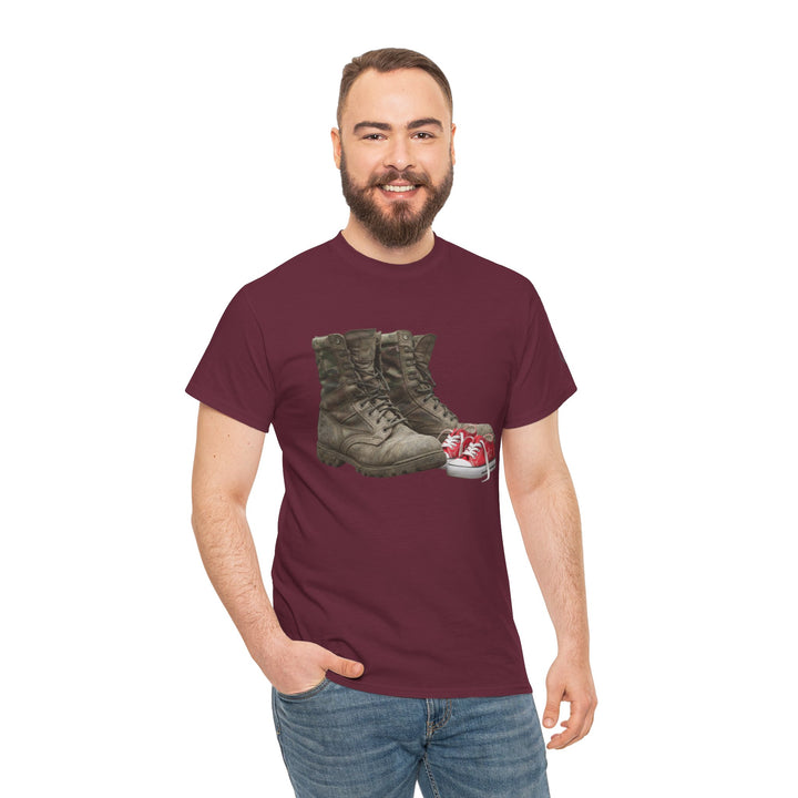Burgundy t-shirt by S&amp;W Gallus displaying graphics of military boots and baby shoes, worn with blue jeans.