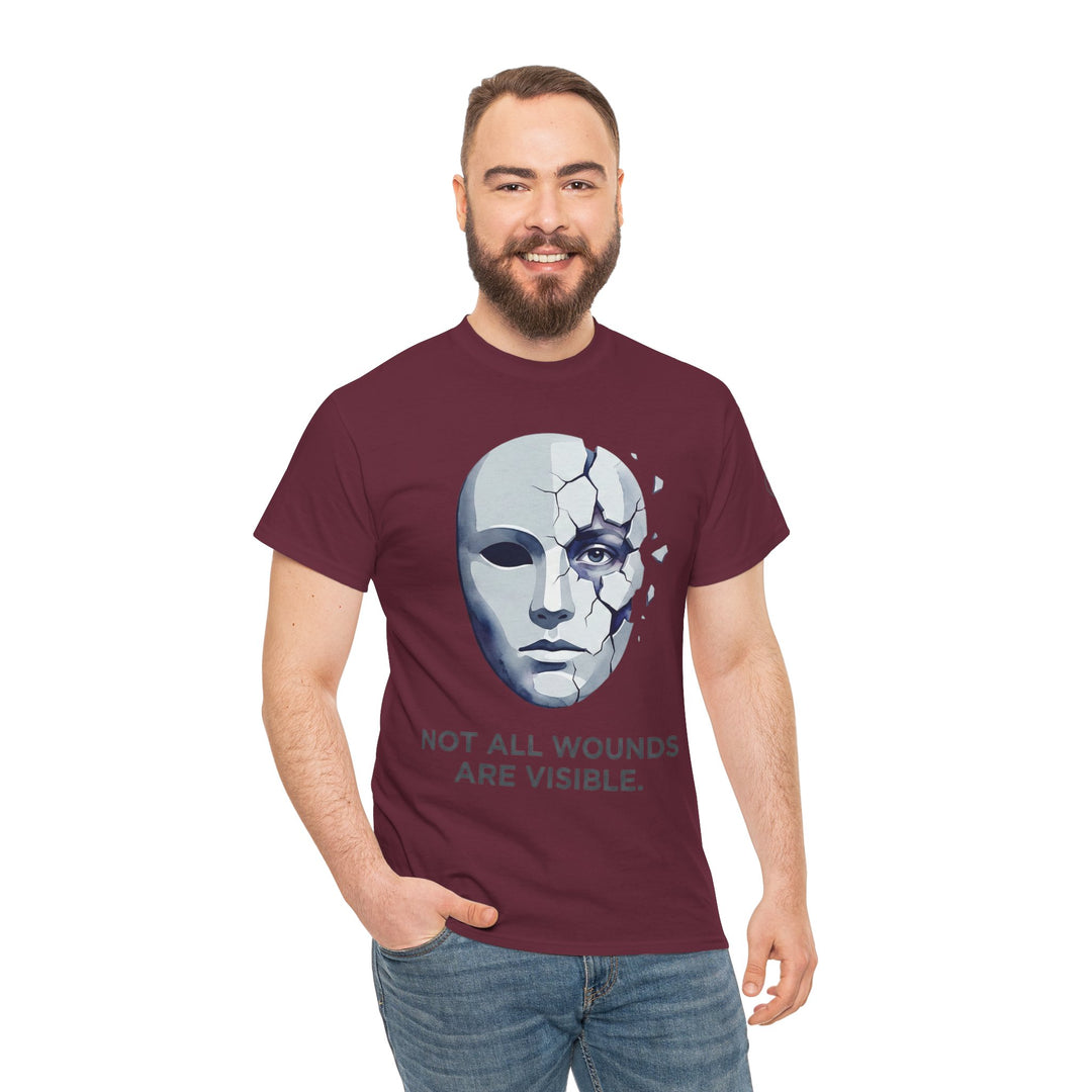 Maroon t-shirt with a cracked mask graphic by Veteran owned, featuring mental health awareness quote, styled on a smiling man with jeans.