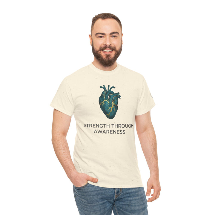 Beige t-shirt with an anatomical heart graphic by Veteran owned, featuring dark text, worn with jeans.