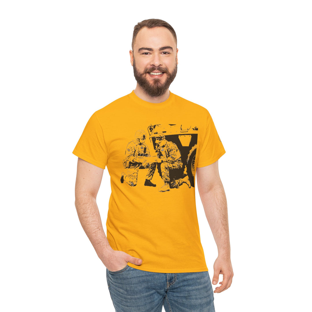 Yellow graphic tee by S&amp;W Gallus featuring a military-themed print, worn with jeans, on a model in a studio shot.