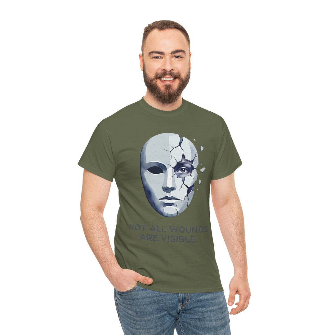 Olive green T-shirt from Veteran Owned, featuring a cracked mask graphic and mental health awareness message, worn with jeans.
