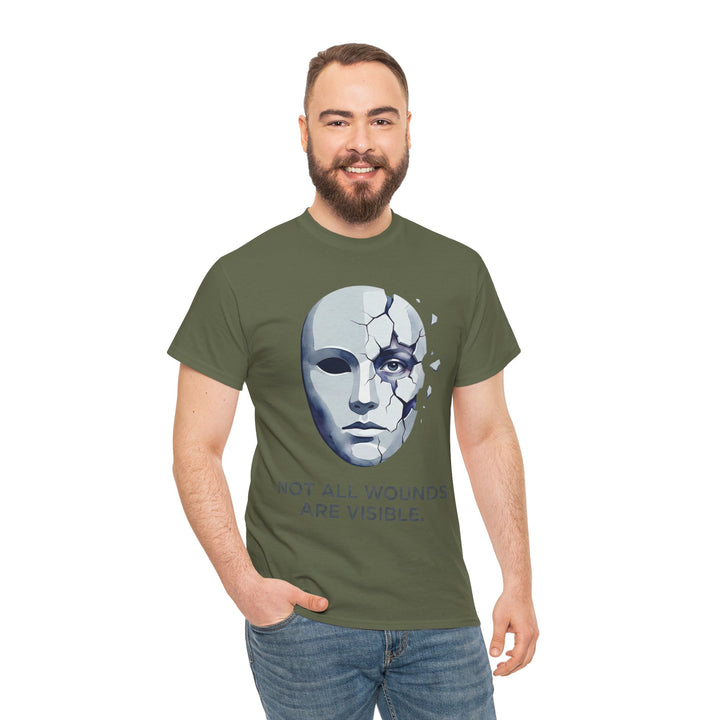 Olive green T-shirt from Veteran Owned, featuring a cracked mask graphic and mental health awareness message, worn with jeans.
