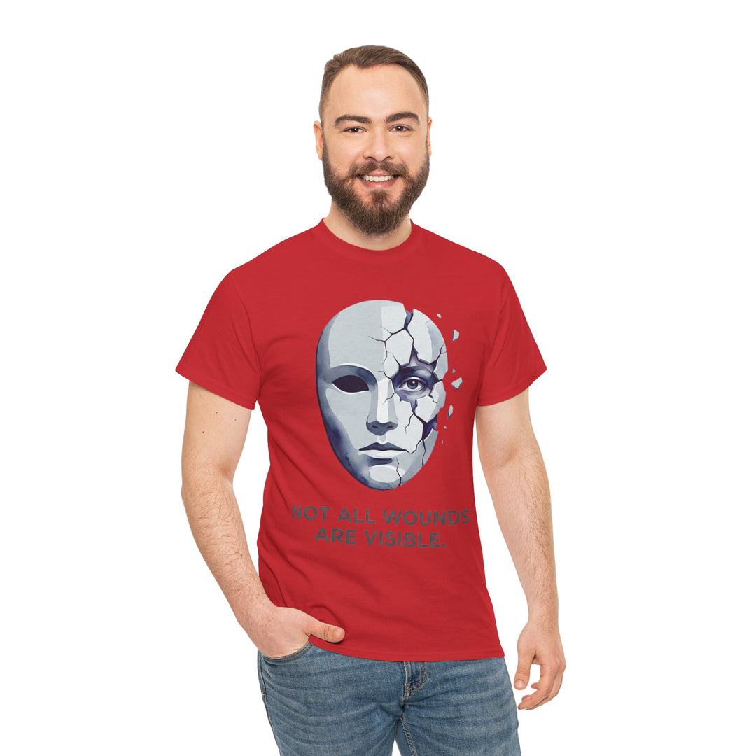 Red t-shirt by Veteran owned, featuring a cracked mask graphic and the quote "Not All Wounds Are Visible", on a model with jeans.